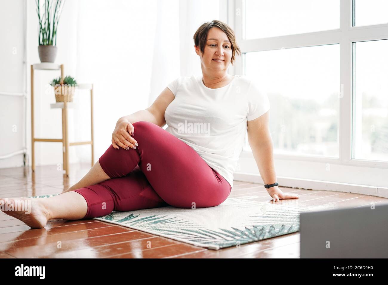 Adult charming woman plus size body positive practice yoga