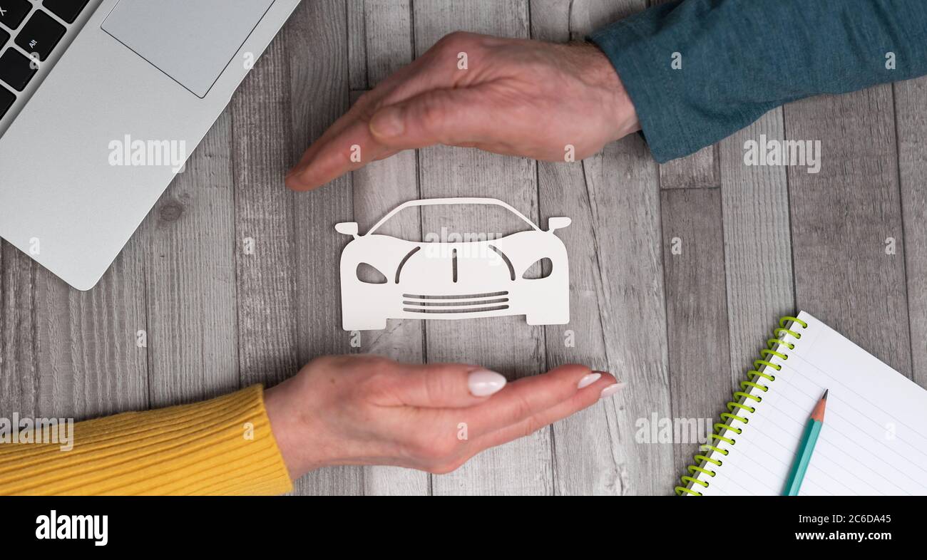 Concept of sports car insurance with hands in a protective gesture