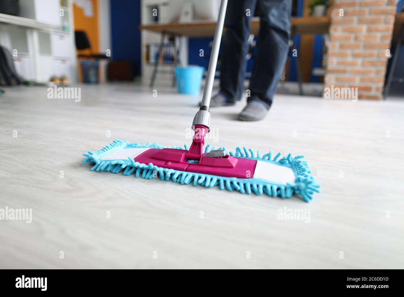 Man in office mops floor Stock Photo Alamy