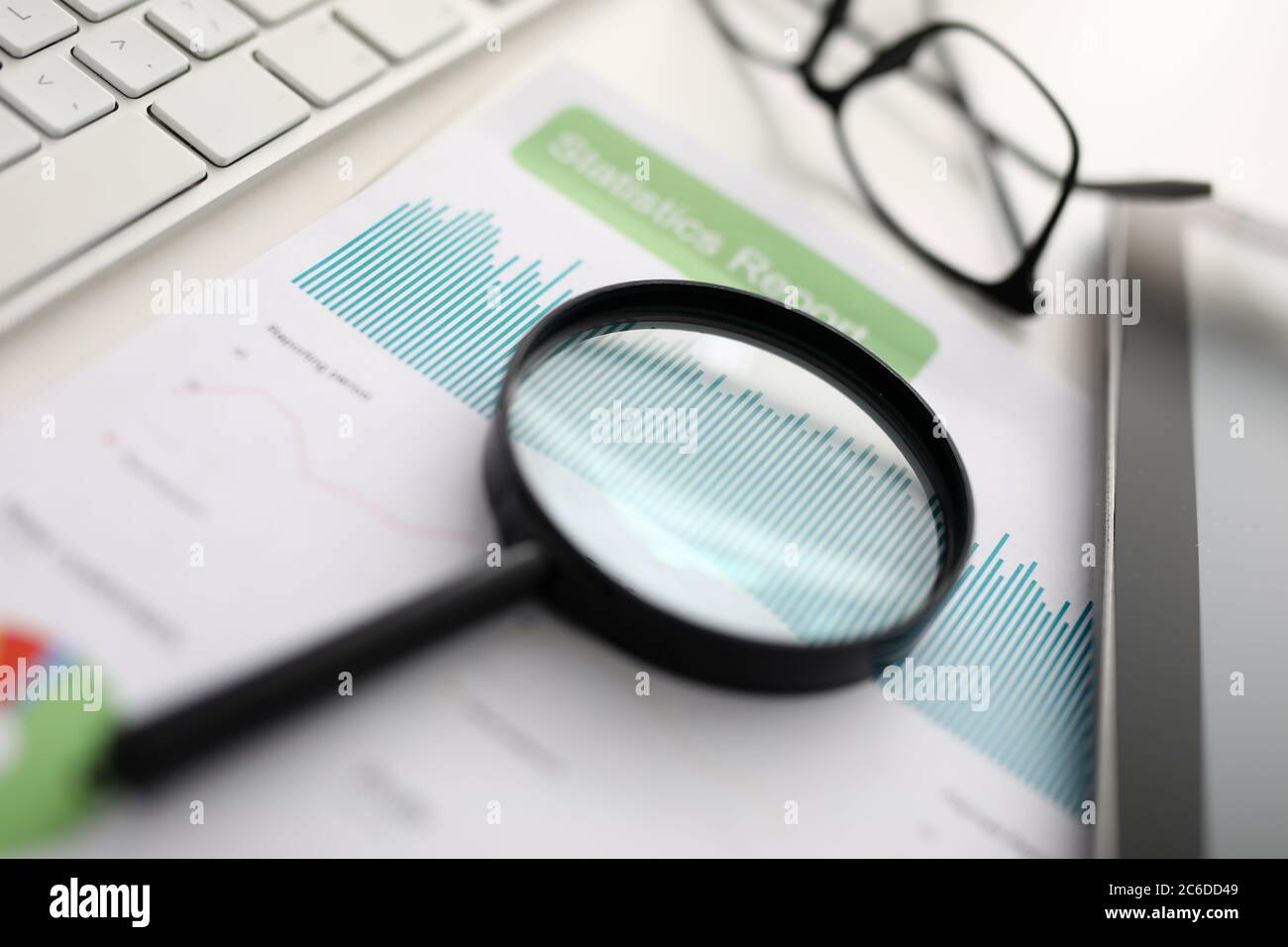 Magnifier glasses lie on table with documents in office Stock Photo
