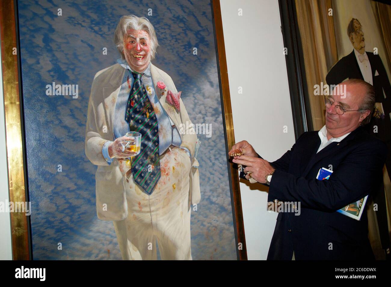 Artist Tim Storrier pictured with his 2014 Packing Room Prize winning portrait of ‘Sir Les’. Tim is holding Les Patterson’s false teeth. Stock Photo