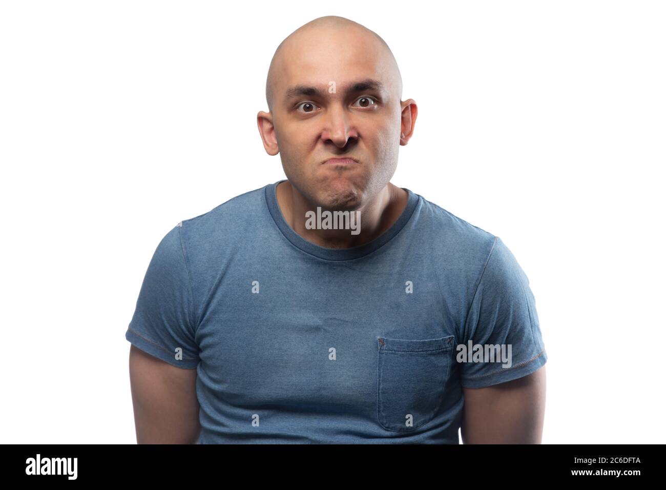 Photo of young bald angry man in blue tee shirt Stock Photo