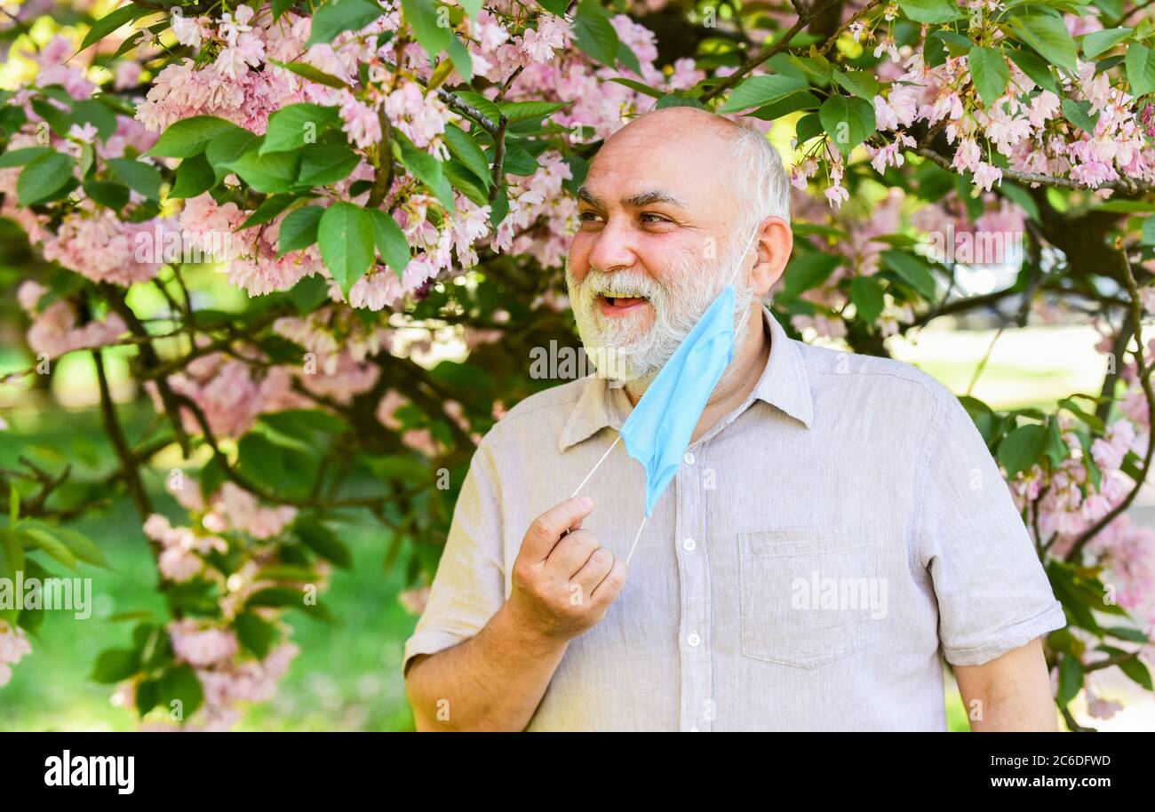 Asthma treatment concept. Pollen allergen. Man and flowers. Respiratory condition. Difficulty in