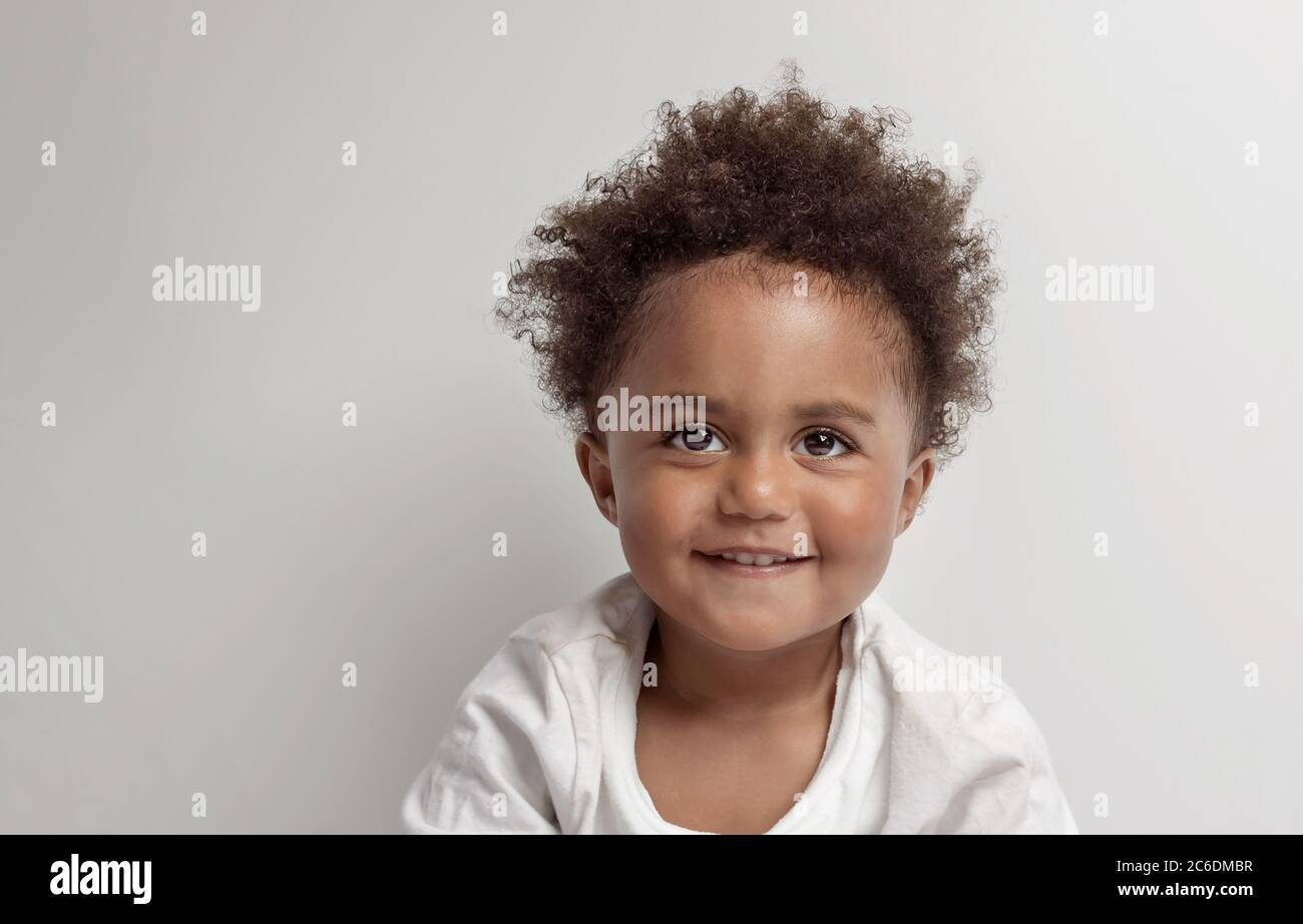 Portrait of a Nice Little African American Boy with Natural Afro Hair Style. isolated on Clear Grey Background. Happy Cute Child Stock Photo - Alamy Portrait of a Nice Little African American Boy with Natural Afro Hair Style. isolated on Clear Grey Background. Happy Cute Child Stock Photo - Alamy