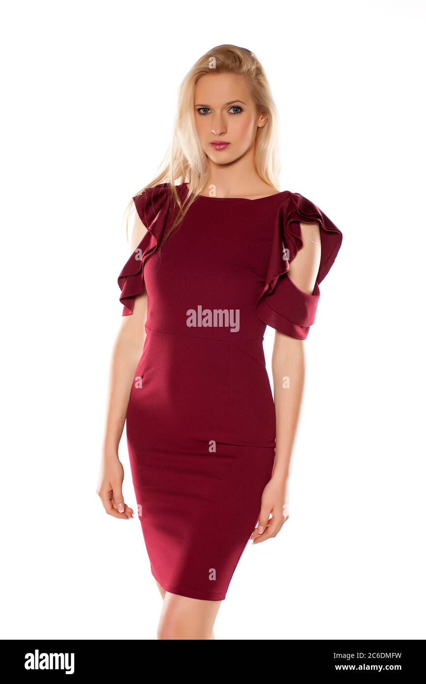 attractive blonde in a short burgundy dress on white background Stock Photo  - Alamy