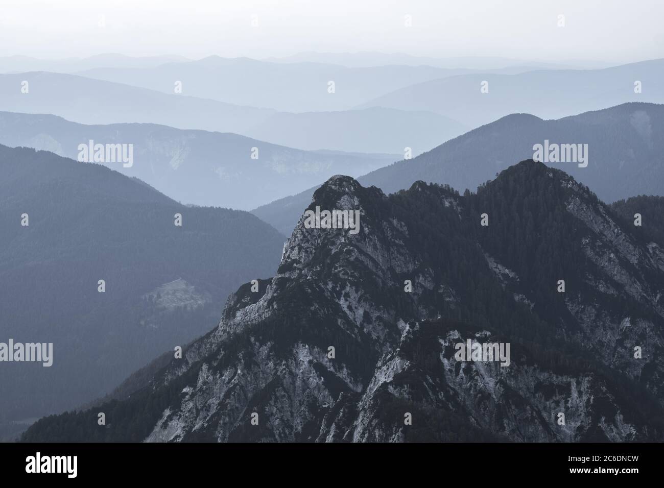 Spectacular view of grey mountain ranges silhouettes and fog in valleys.  Julian Alps, Triglav National Park, Slovenia. View from Mountain Slemenova  Stock Photo - Alamy
