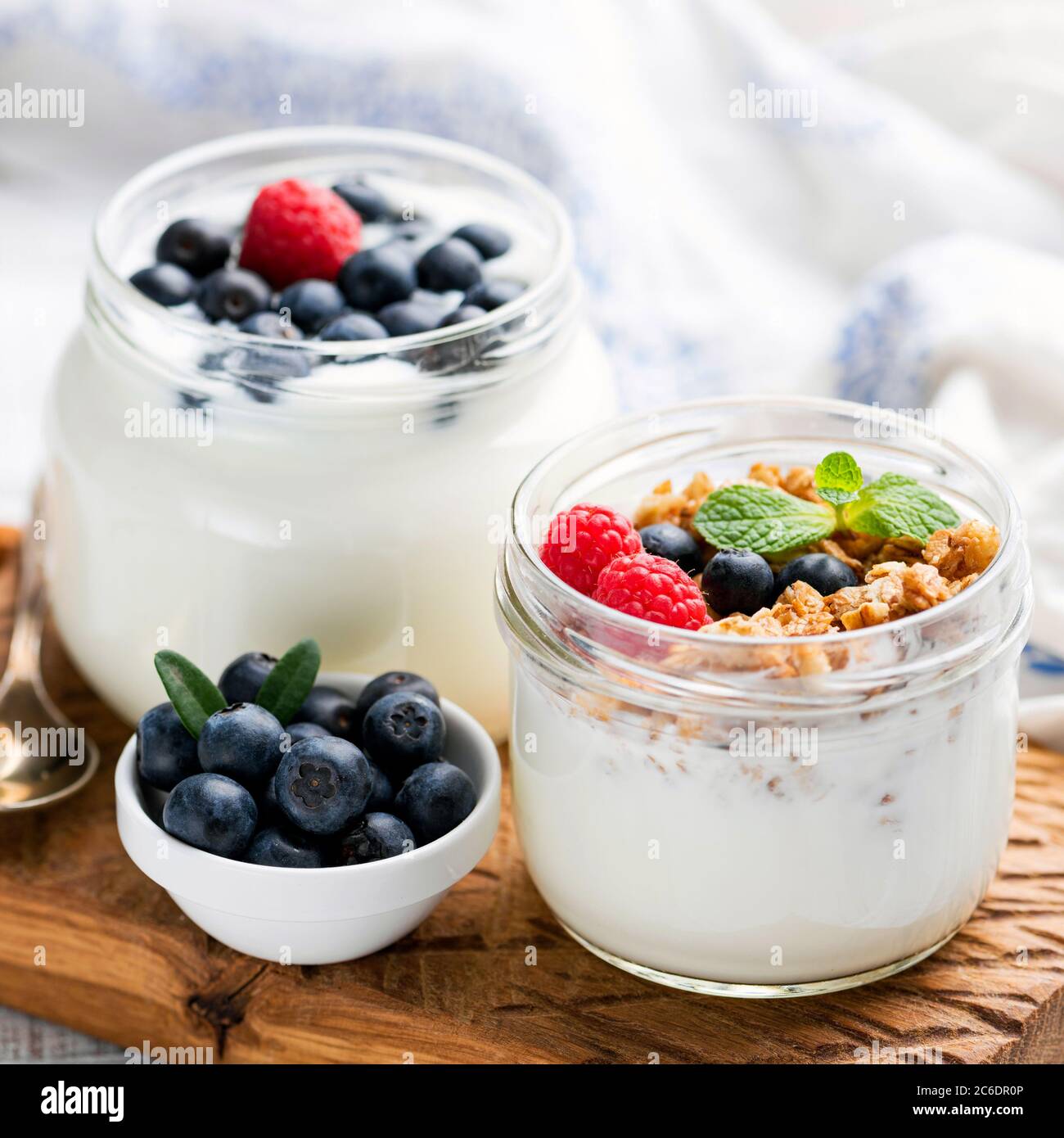 Greek yogurt with granola and berries in a jar. Healthy yogurt snack with crunchy oats granola