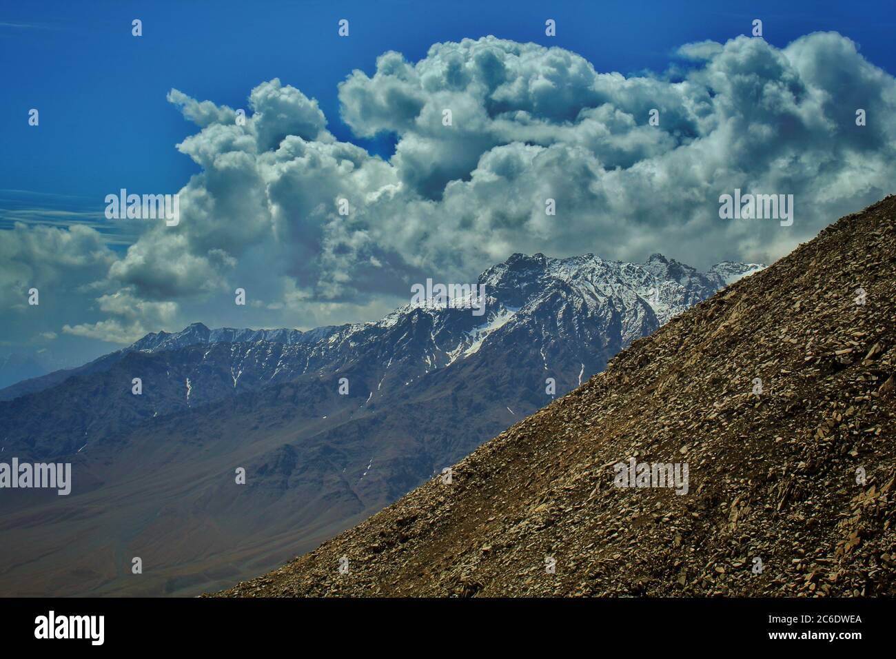 scenic view of a mountains with a blue sky and clouds above. Stock Photo