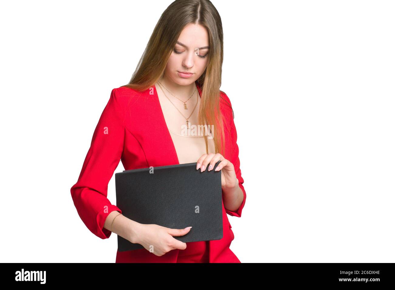 A young business woman in a red suit a background isolated in white ...