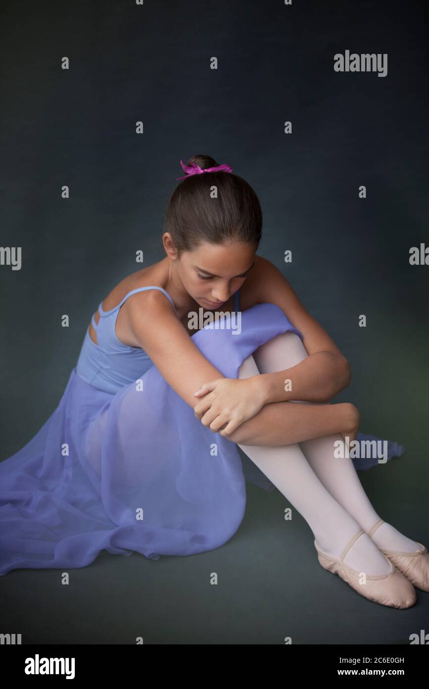 Ballerina hugging knees Stock Photo