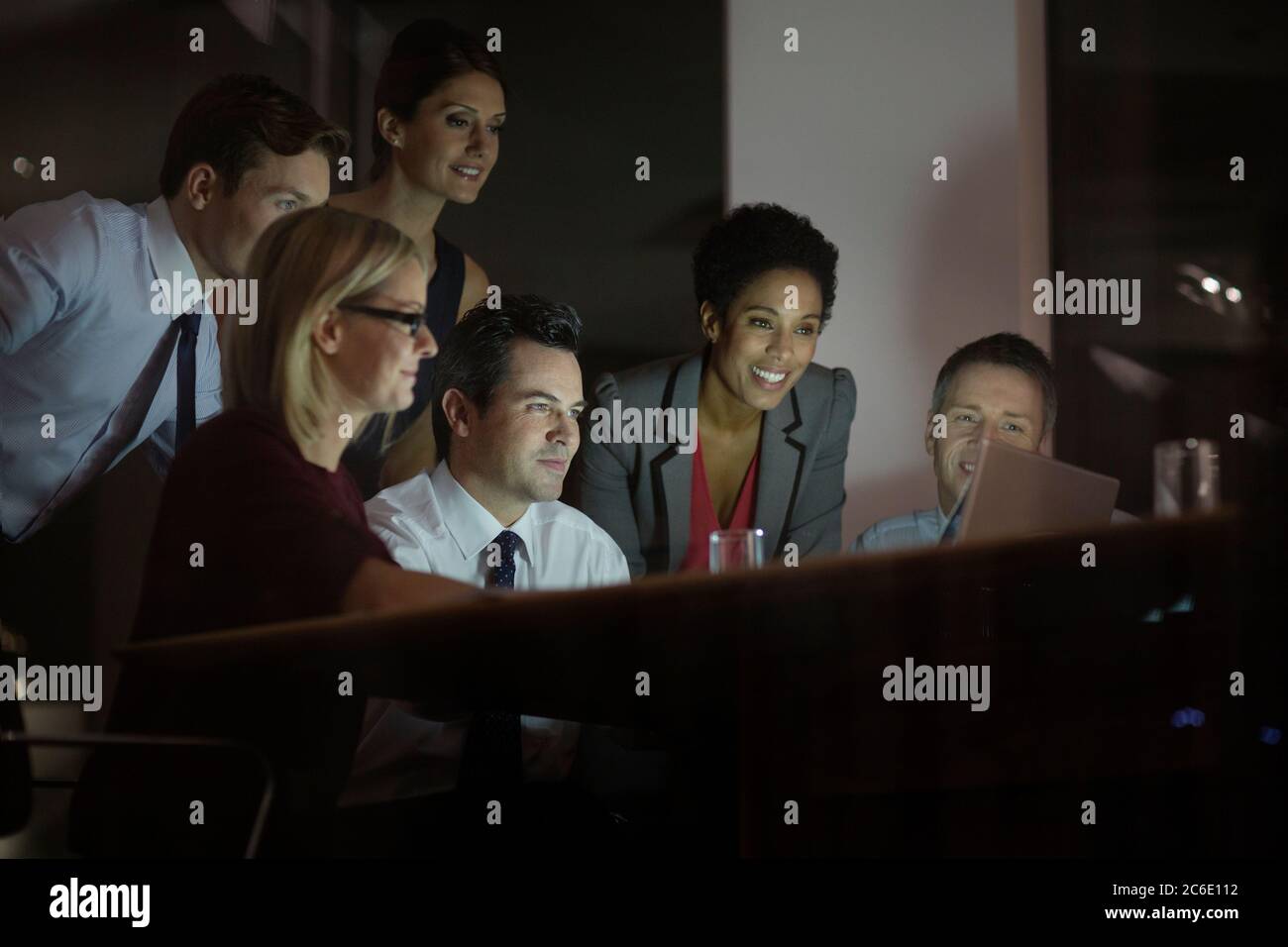 Business people working at laptop in conference room at night Stock Photo