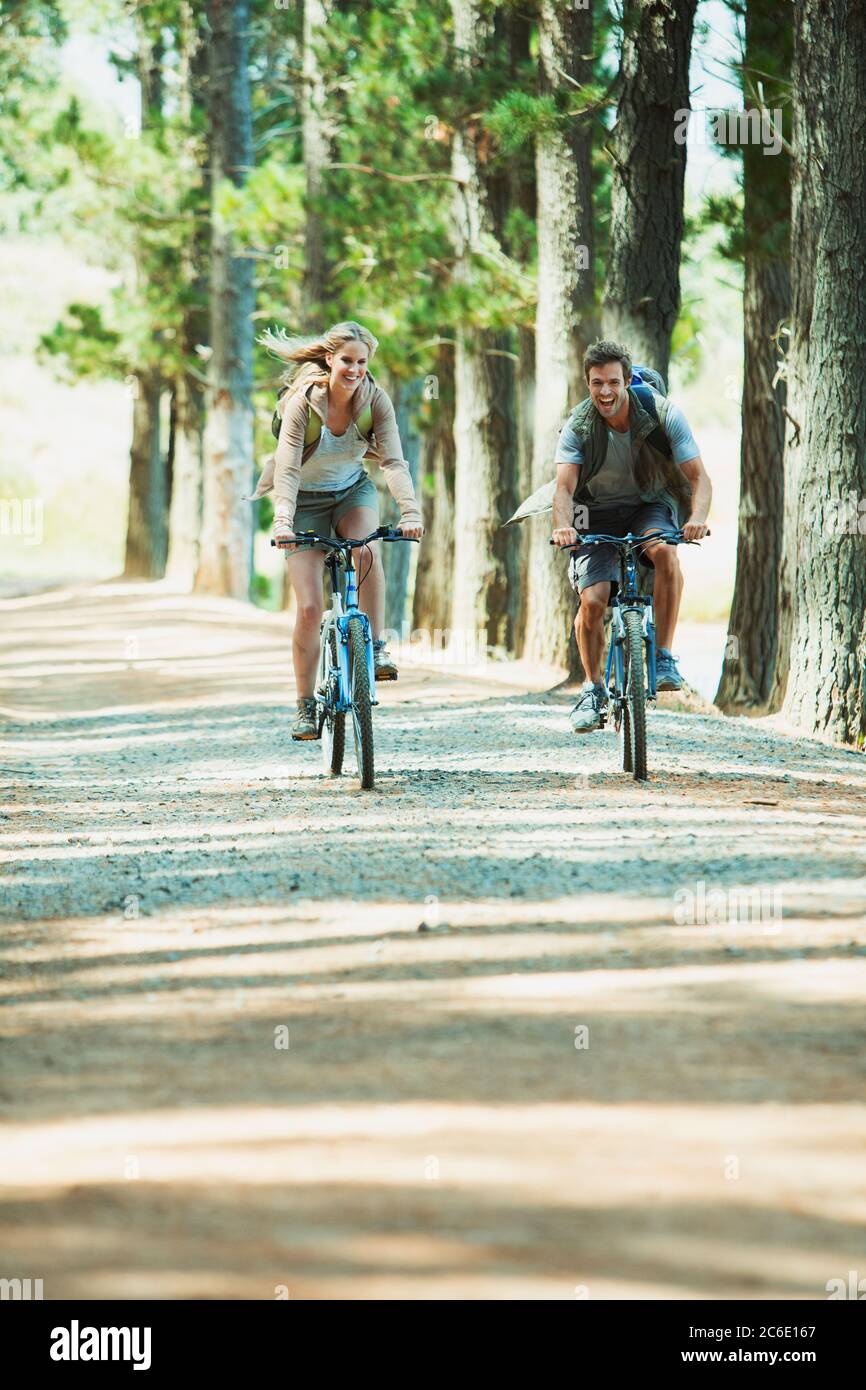 Couple riding mountain bikes in woods Stock Photo - Alamy