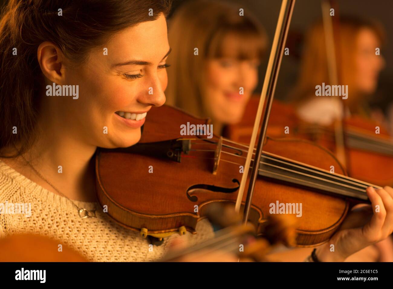 Smiling violinist performing Stock Photo