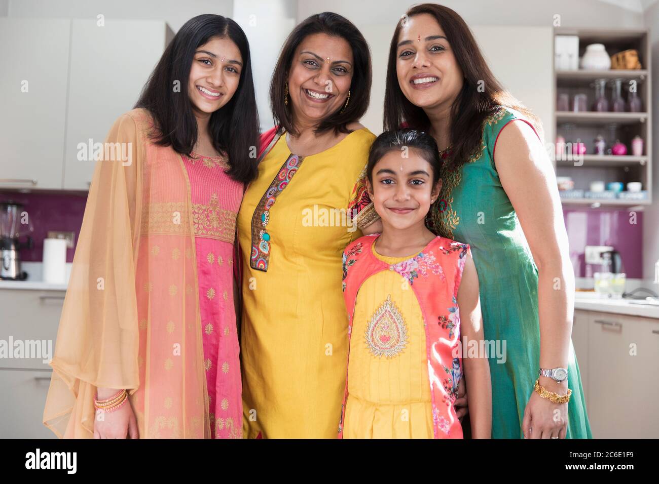Portrait happy multigenerational Indian women in traditional saris Stock Photo