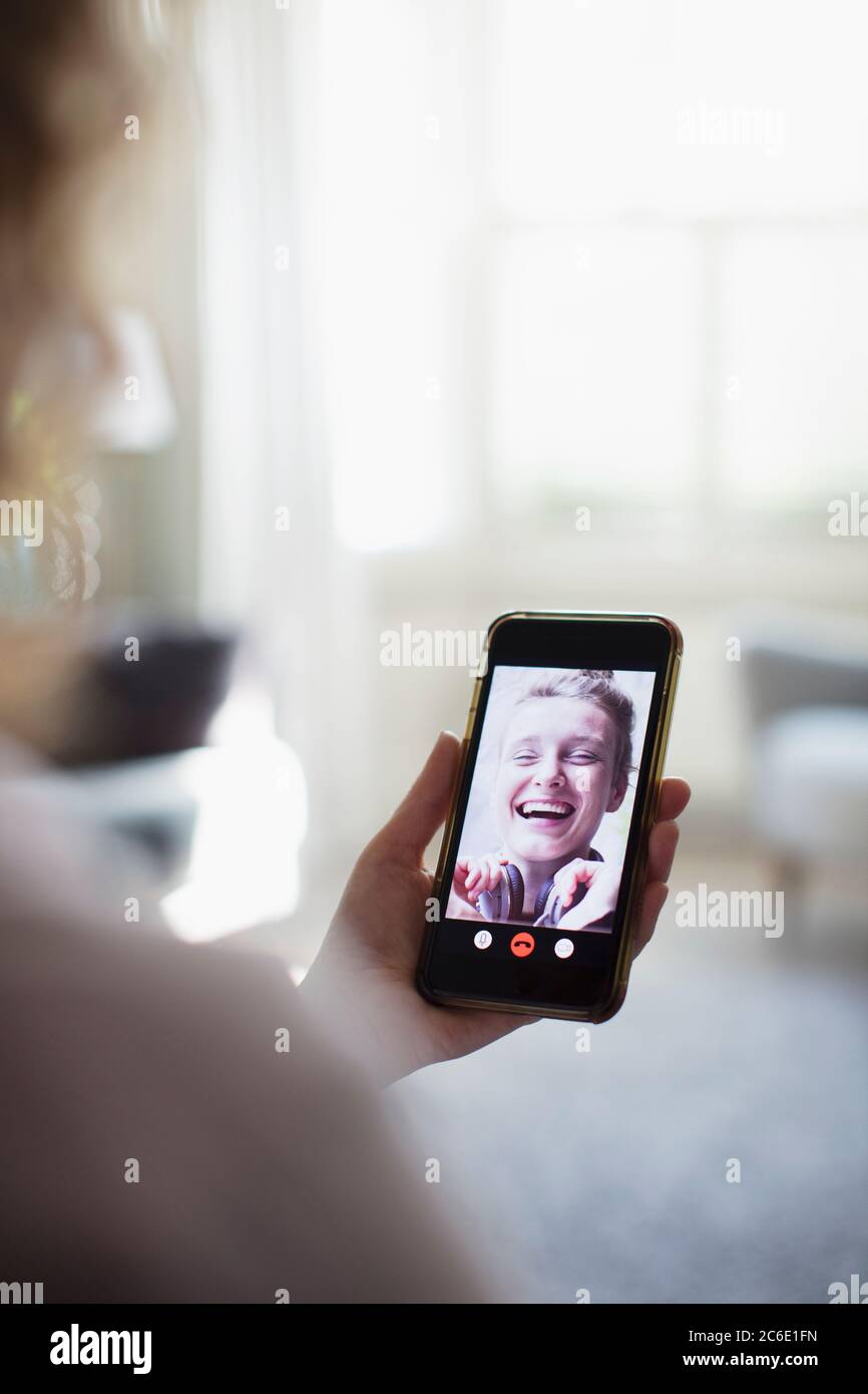 Happy women friends video chatting on smart phone screen Stock Photo