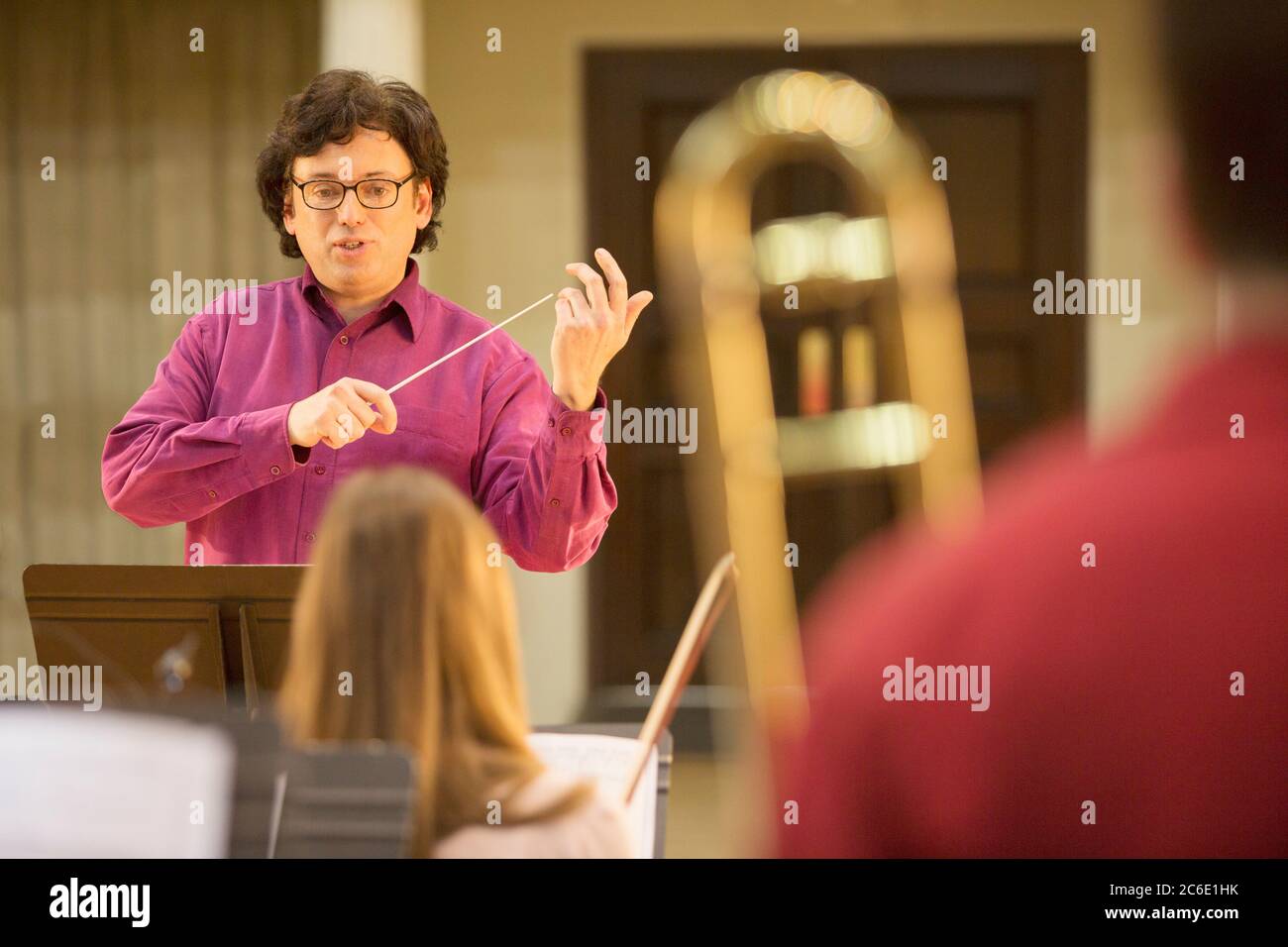 Conductor leading orchestra in practice Stock Photo