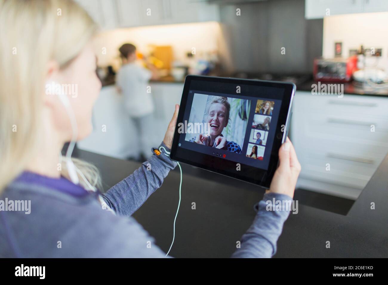 Woman video chatting with friends on digital tablet Stock Photo