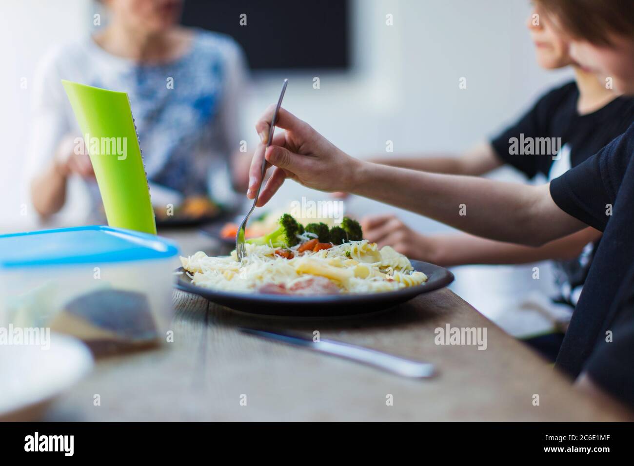 Close up family eating at dining table Stock Photo
