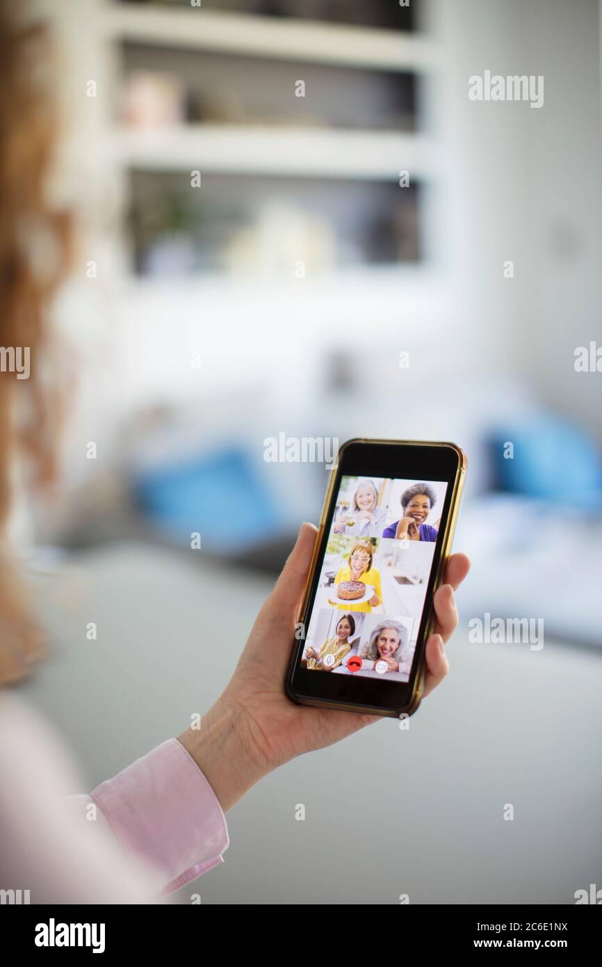 Senior women friends video conferencing on smart phone screen Stock Photo