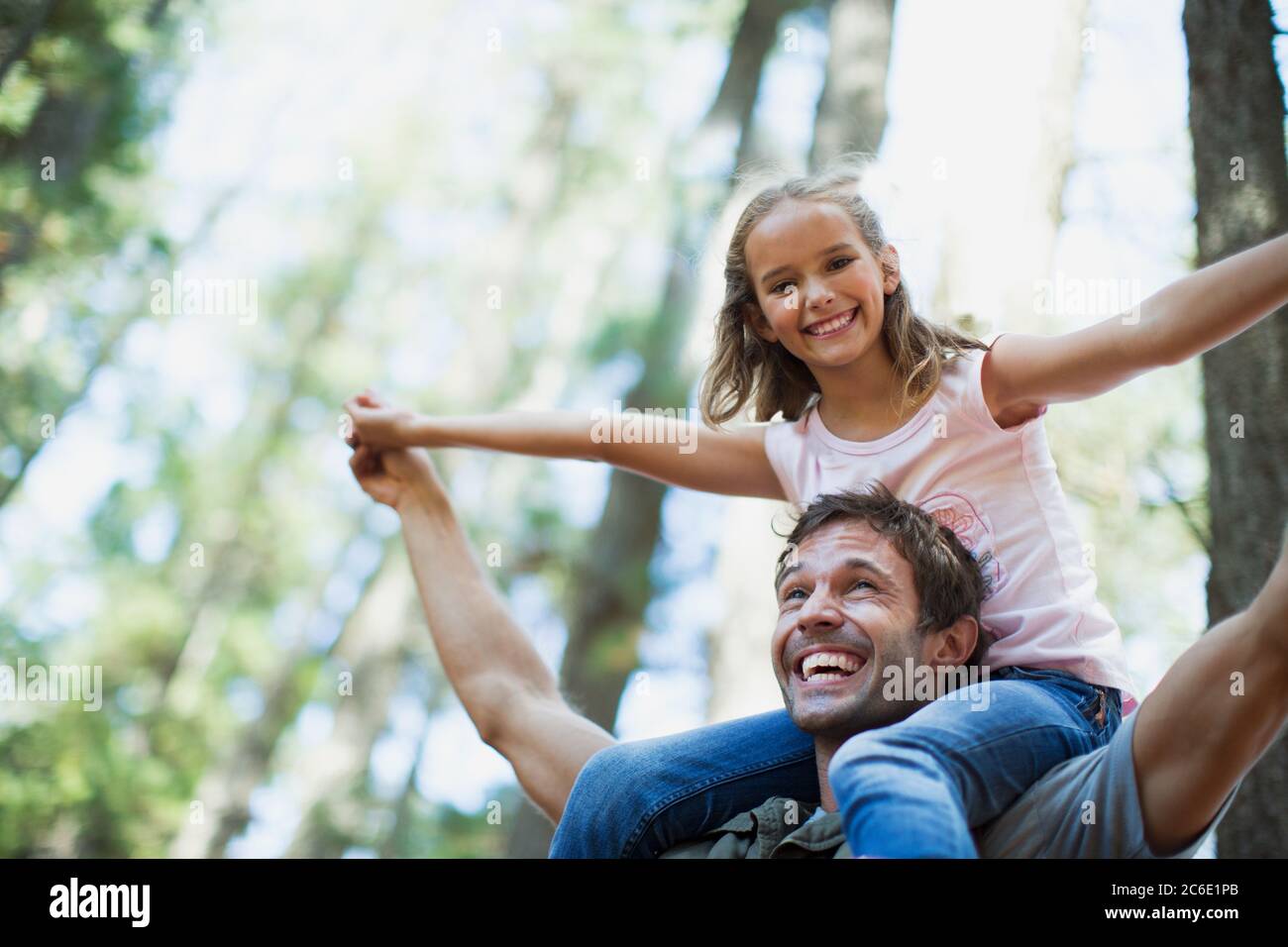 Father carrying daughter on shoulders in woods Stock Photo - Alamy