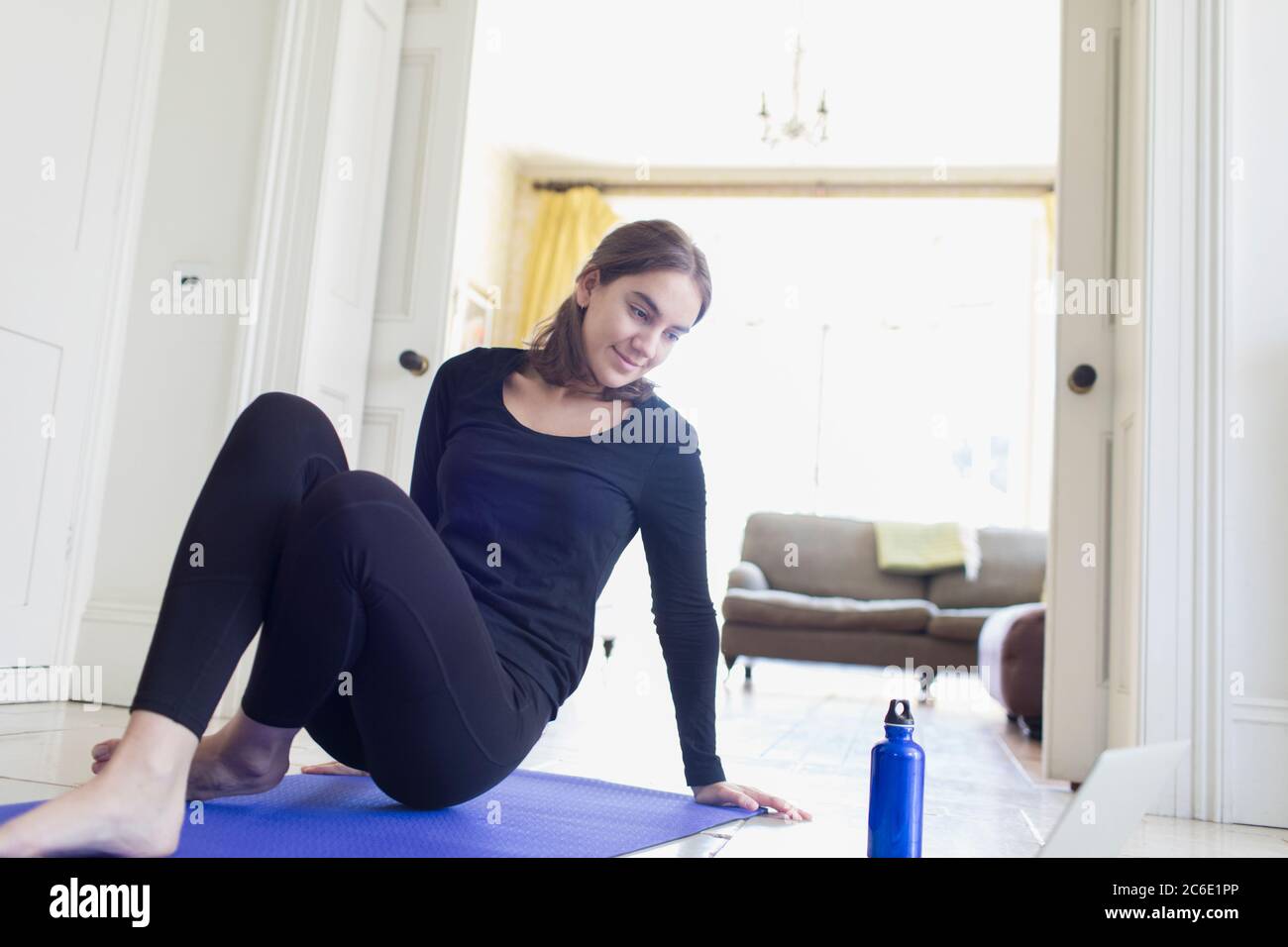 Teenage girl exercising online at home Stock Photo