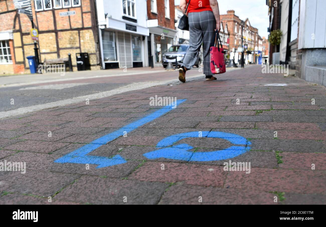Shops returning on June 15th 2020, as the Coronavirus Covid-19 Pandemic Lockdown gradually lifts.The council have spray painted Godalming High Street in Surrey with lines, arrows and coloured prompts, to help customers once there way back.  Strict two metre social distancing is still in place for now.  Picture taken 27th May 2020 Stock Photo