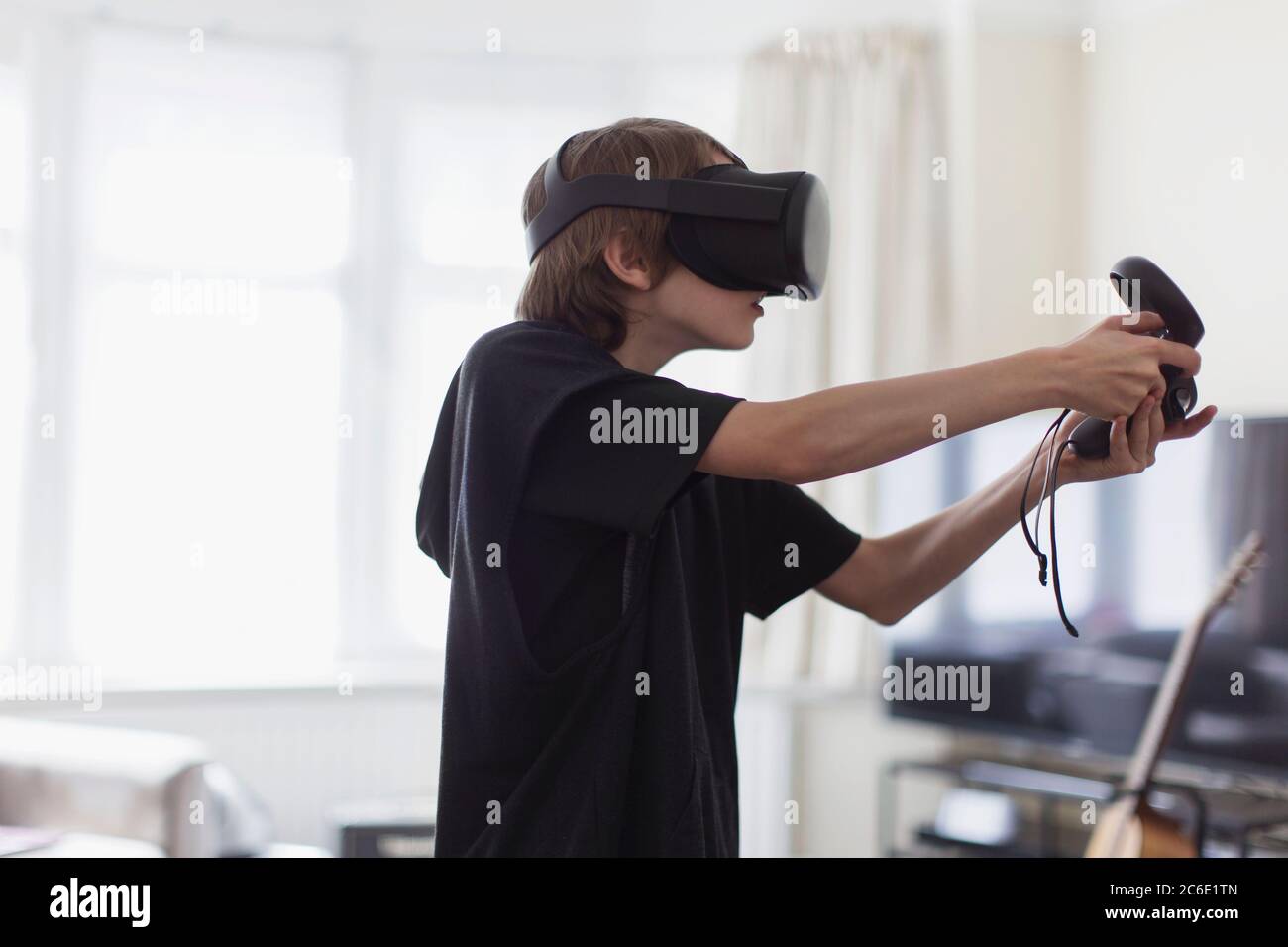 Boy playing video game with VRS goggles Stock Photo Alamy