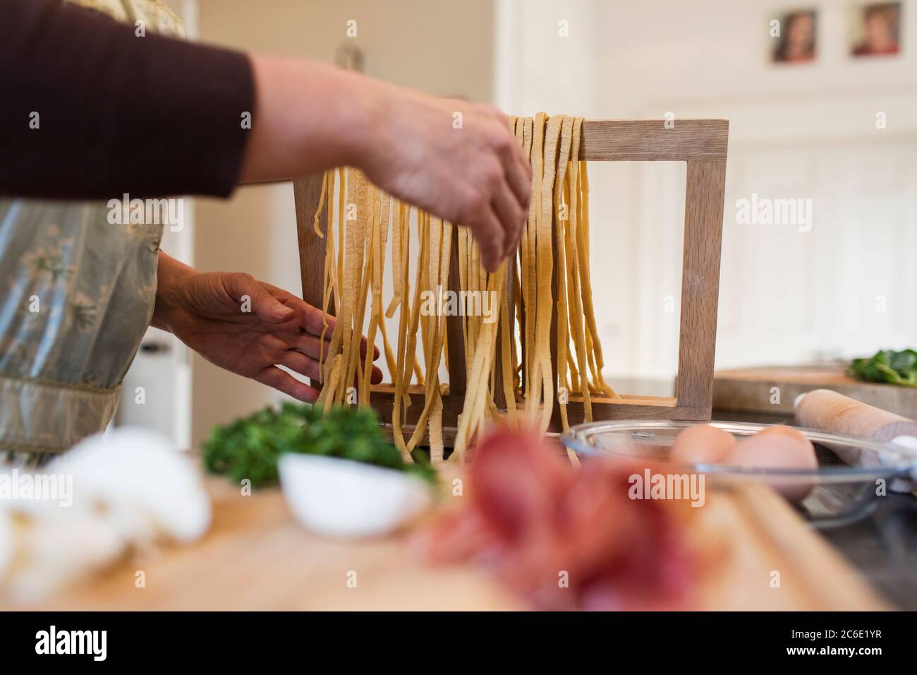 Woman making fresh homemade pasta in kitchen Stock Photo