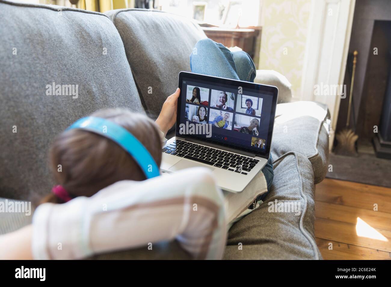 Friends video chatting on laptop screen on living room sofa Stock Photo