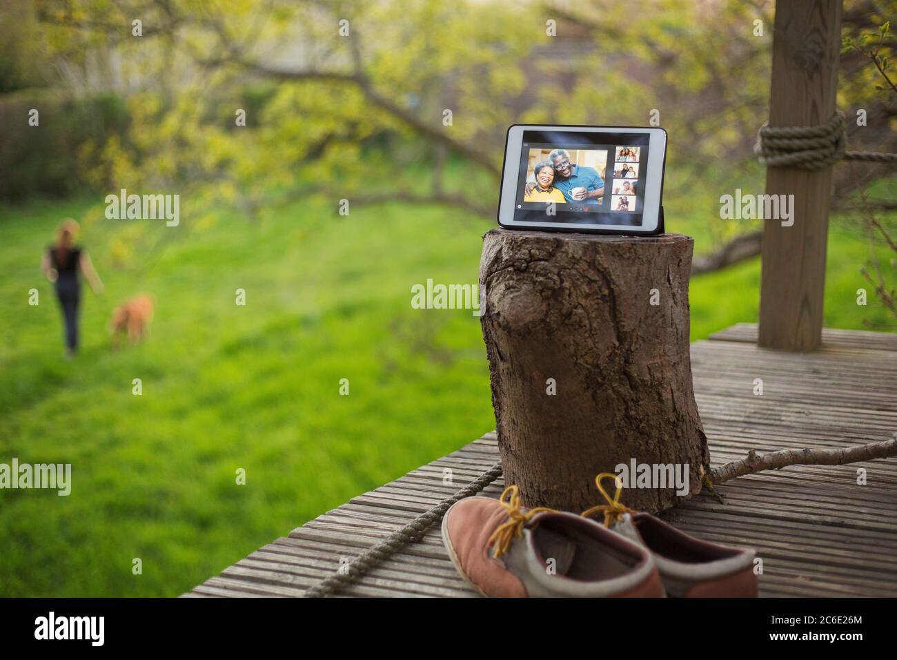Family video chatting on digital tablet screen on balcony Stock Photo