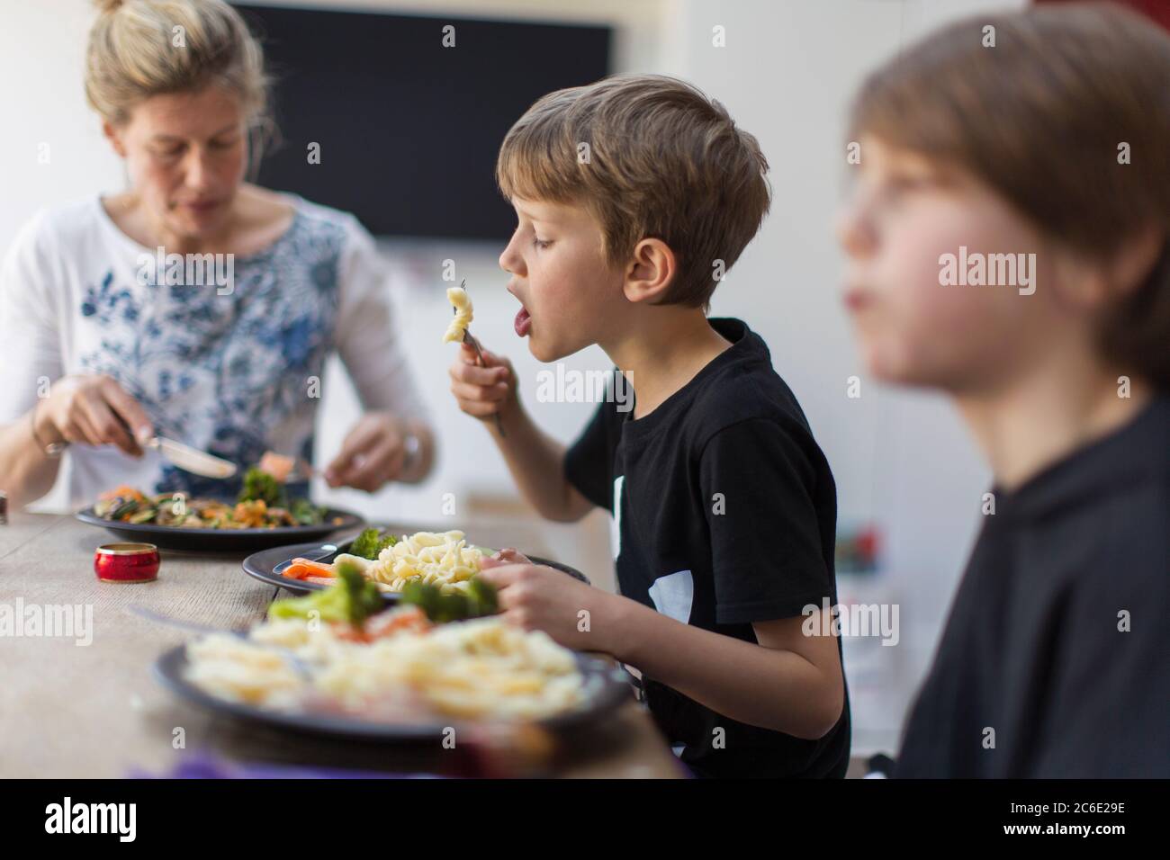 Family eating lunch at dining table Stock Photo