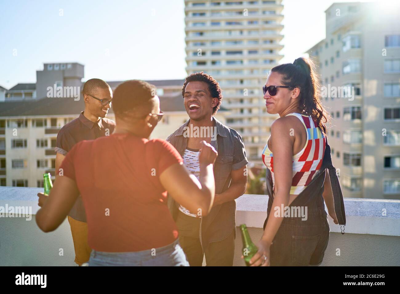 Happy young friends dancing on urban rooftop balcony Stock Photo