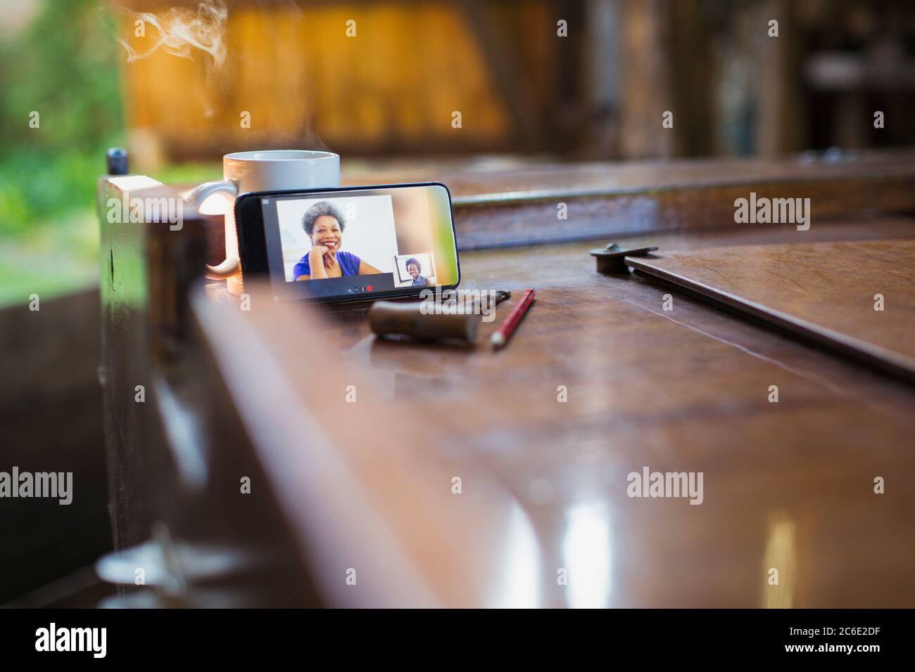 Colleagues video chatting on smart phone screen Stock Photo