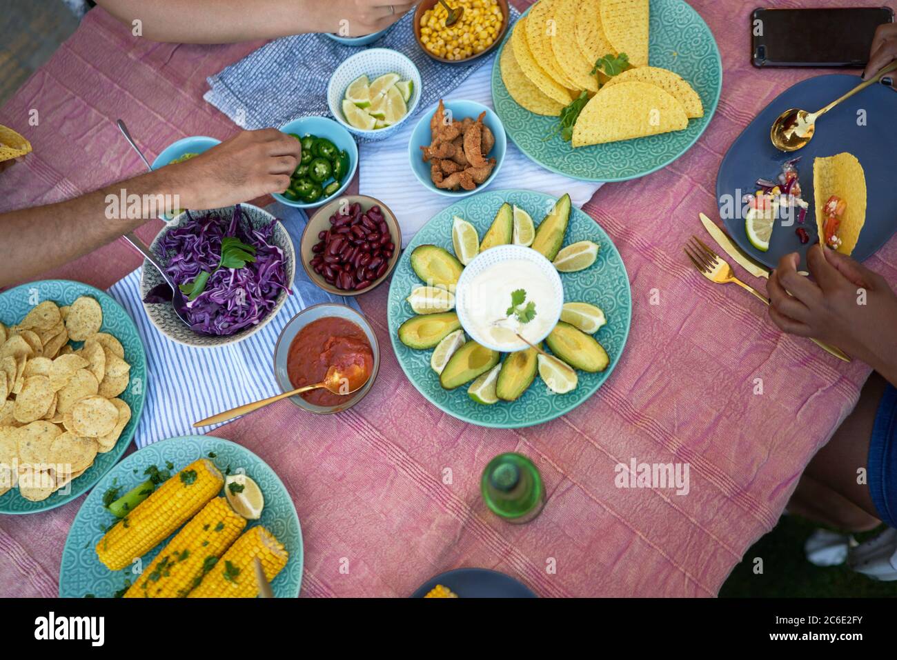 Taco shells and ingredients on patio table Stock Photo