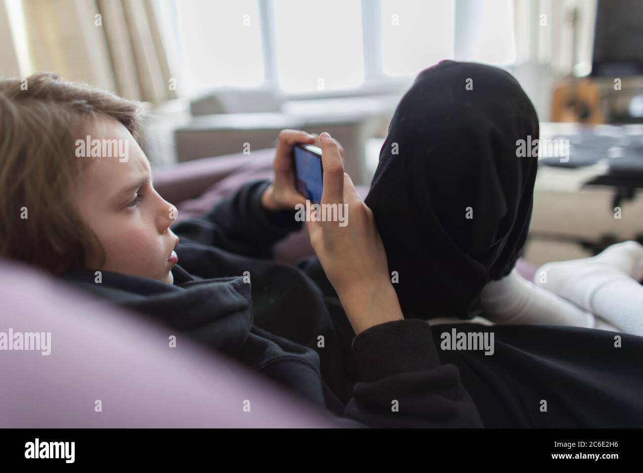 Boy playing video game with smart phone Stock Photo