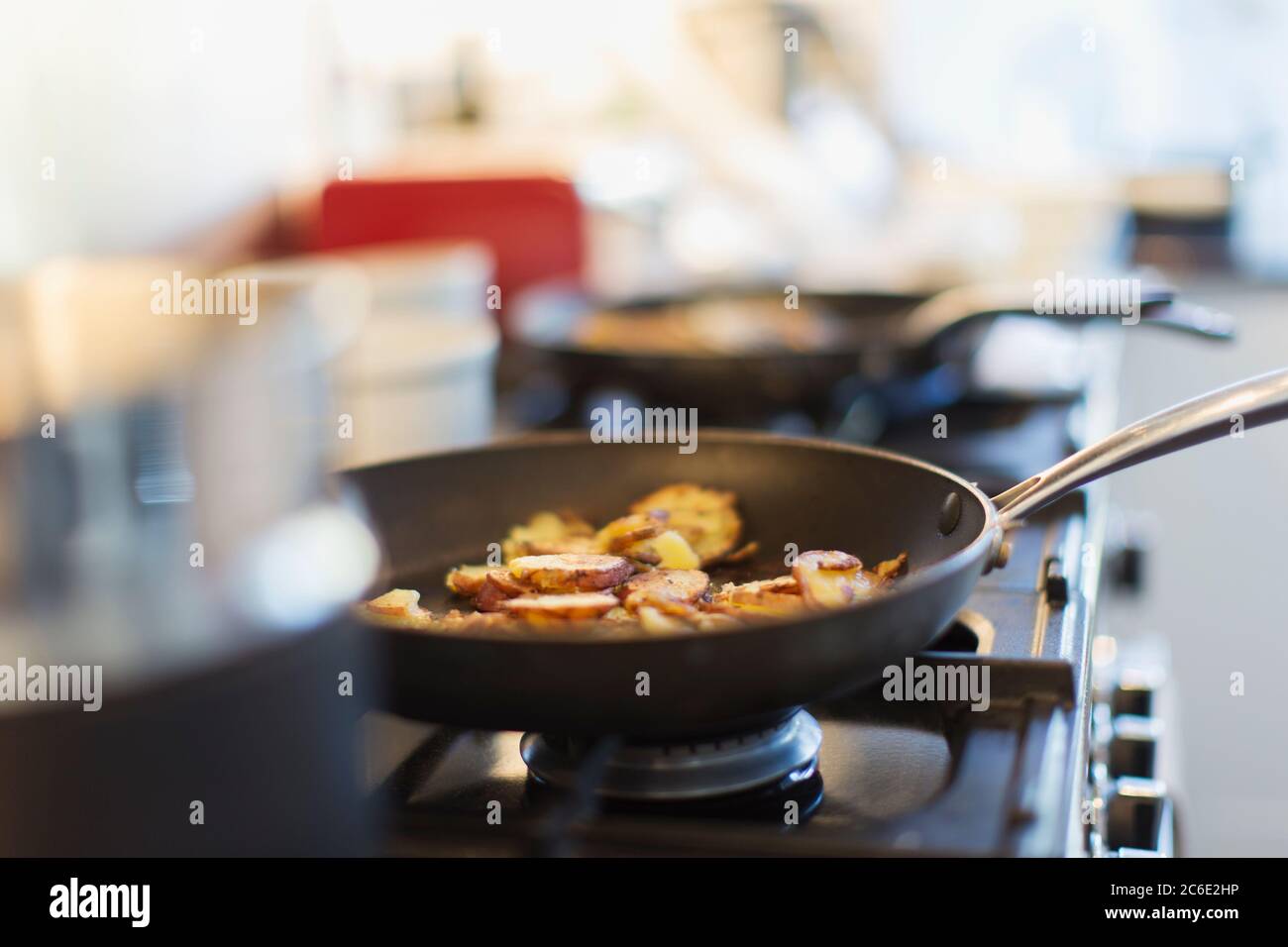Close up food cooking in skillet on stove Stock Photo