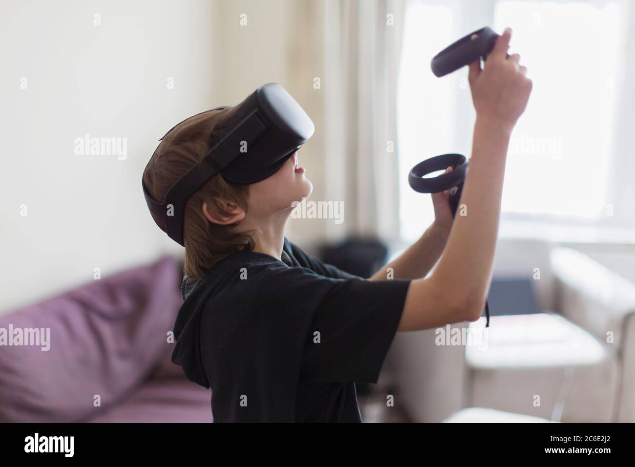 Boy playing video game with VRS goggles Stock Photo
