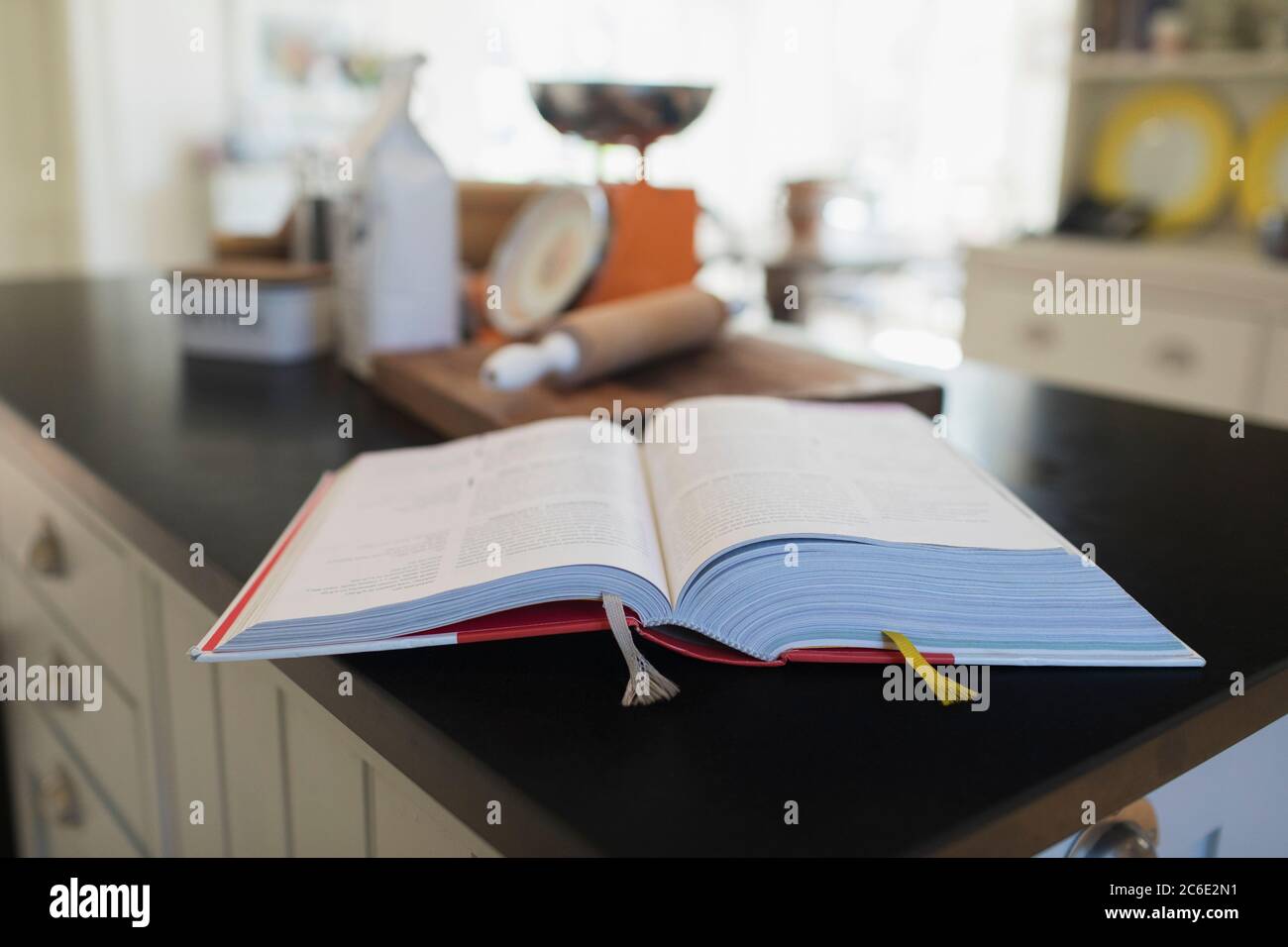 Cookbook open on kitchen counter Stock Photo
