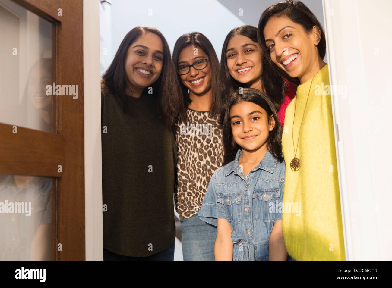 Portrait happy Indian women and girls in doorway Stock Photo