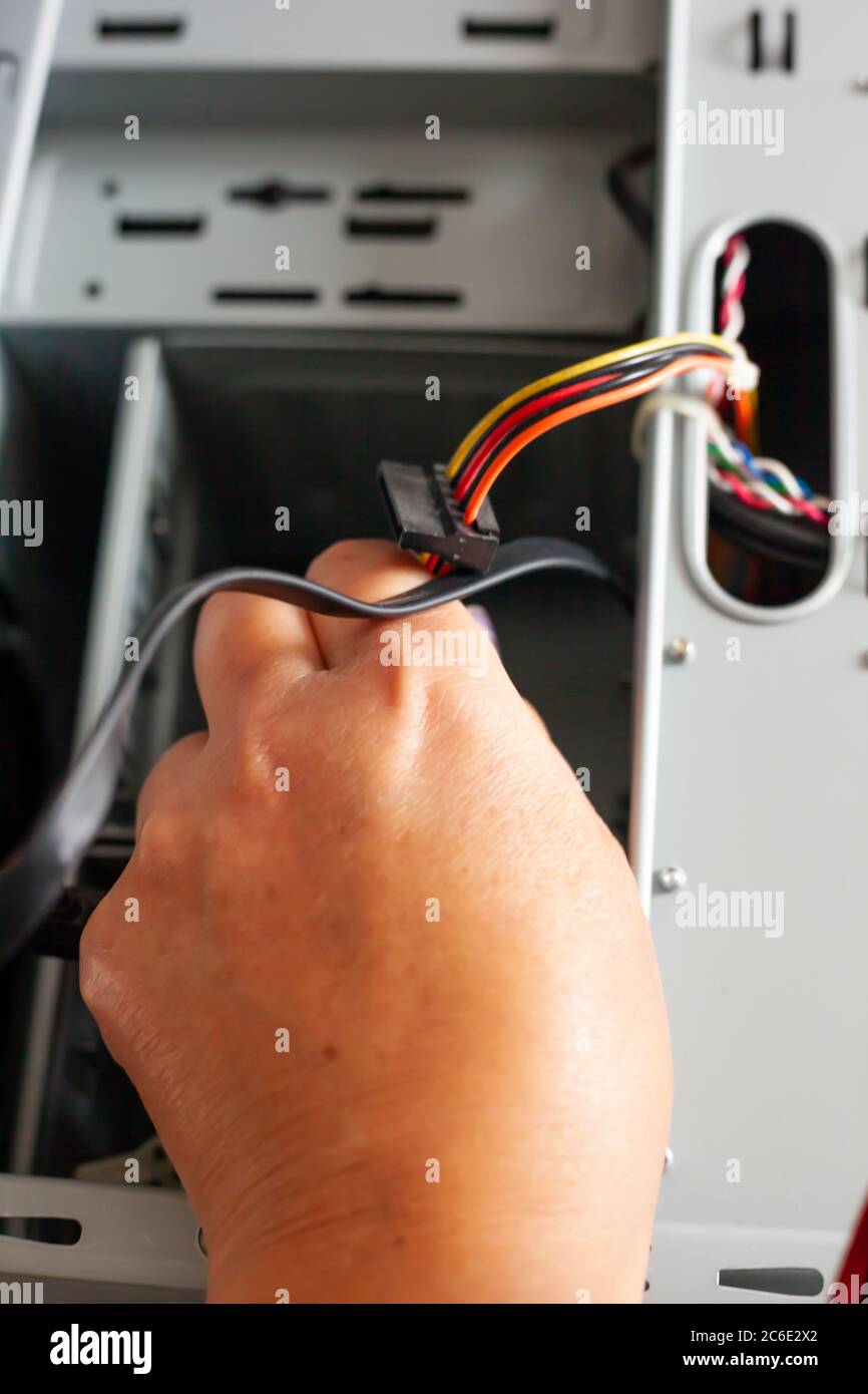 Inside tech highresolution closeup of a hand holding computer cable