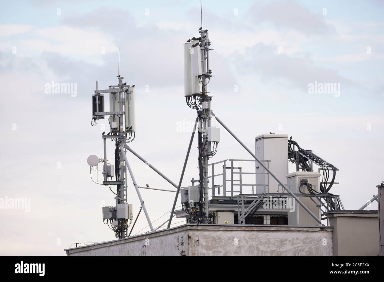 A cellular base station is seen on a building  rooftop in central Warsaw, Poland on July 8, 2020. Stock Photo