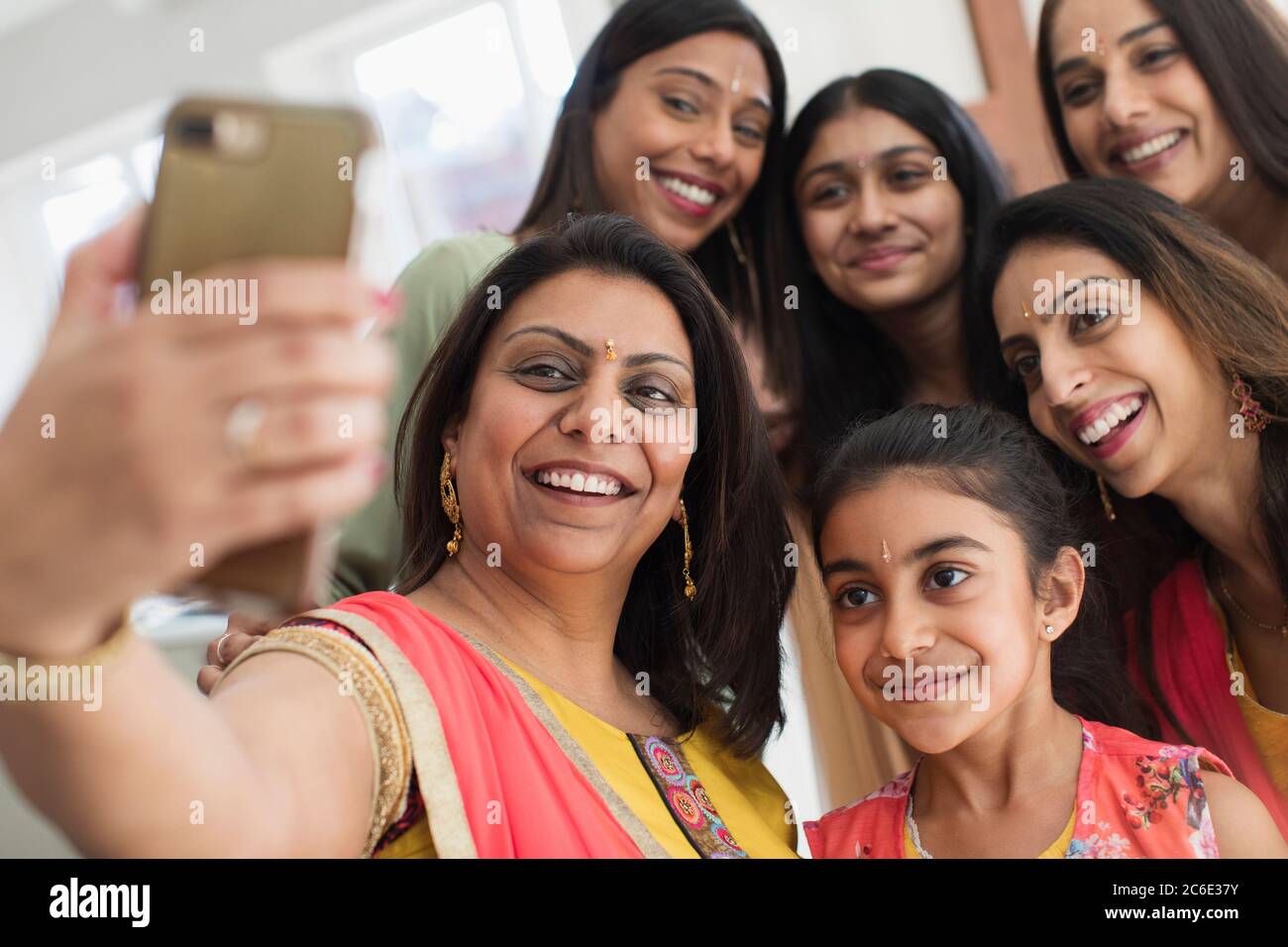 Happy Indian women and girls in bindis taking selfie Stock Photo