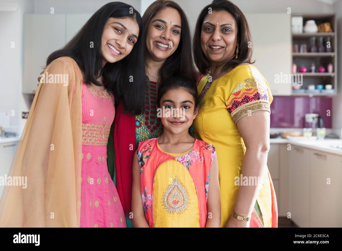 Portrait happy Indian mothers and daughters in saris Stock Photo