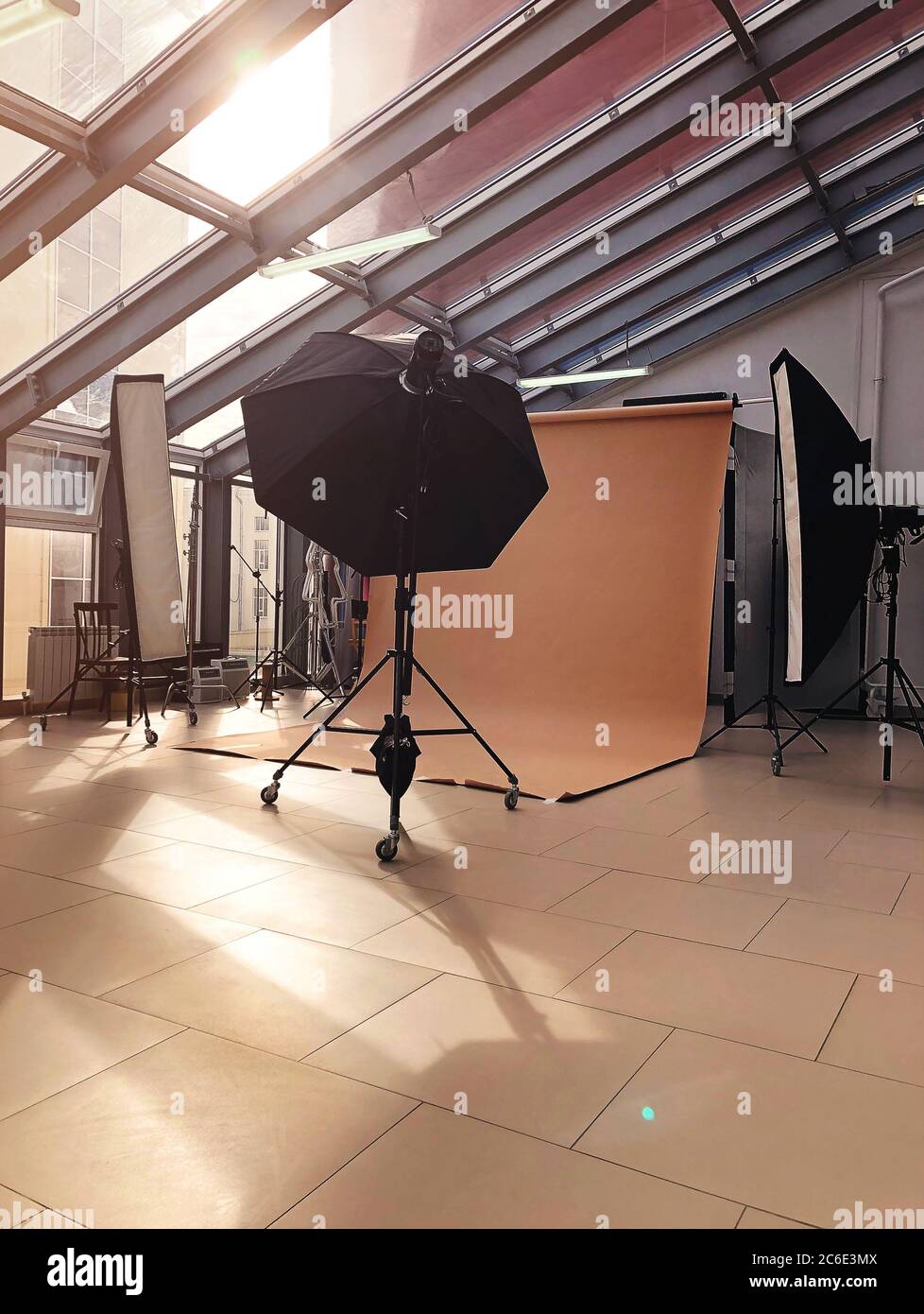 Various professional lightning and lamps placed in modern studio of photography during daytime Stock Photo
