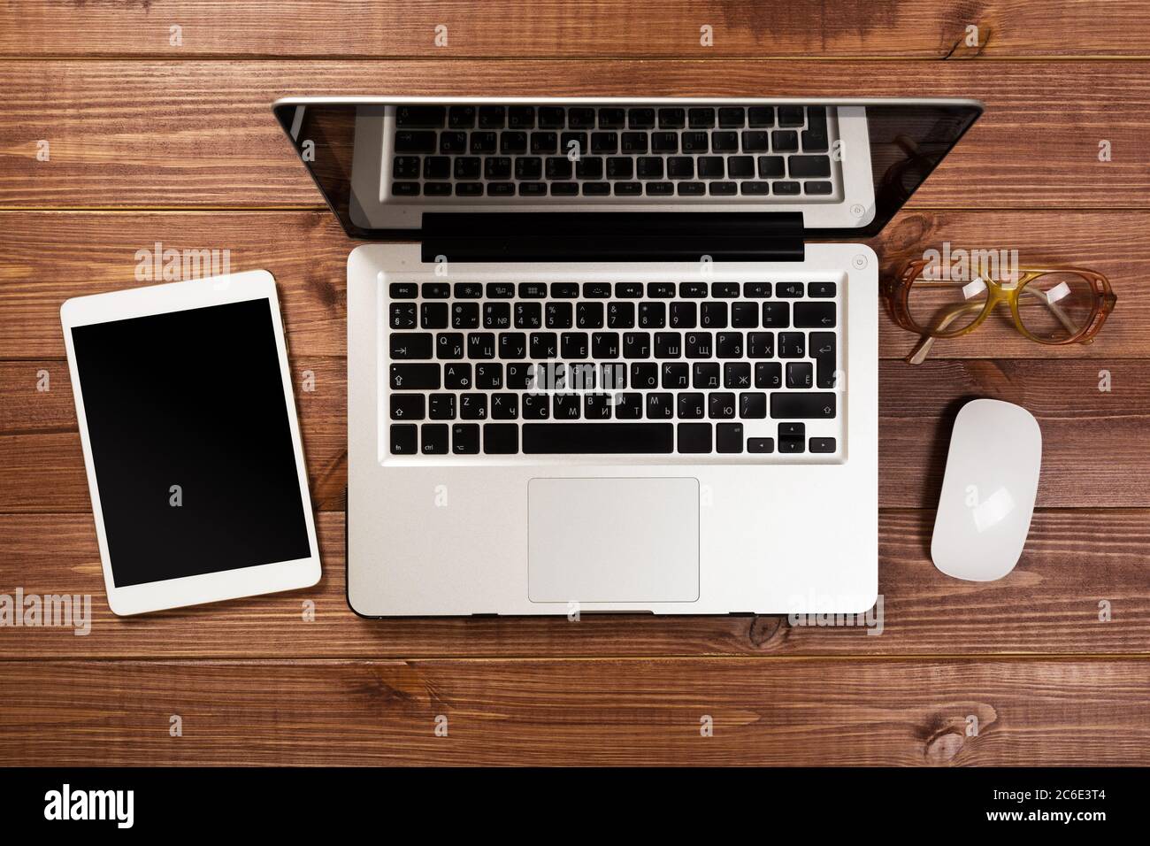 office stuff with notepad, laptop and coffee cup mouse notepad top view shot. Stock Photo