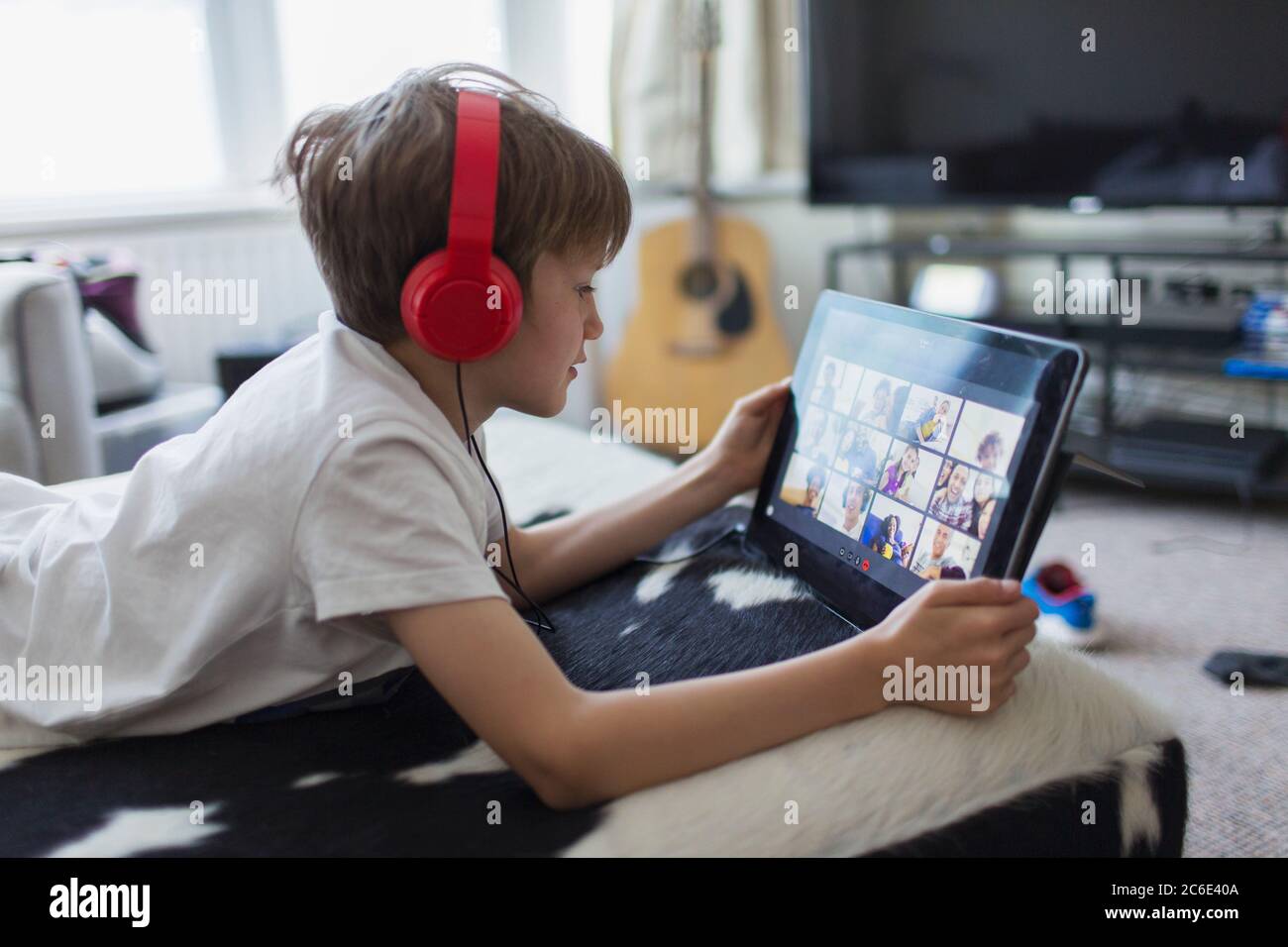 Boy with headphones and digital tablet homeschooling Stock Photo