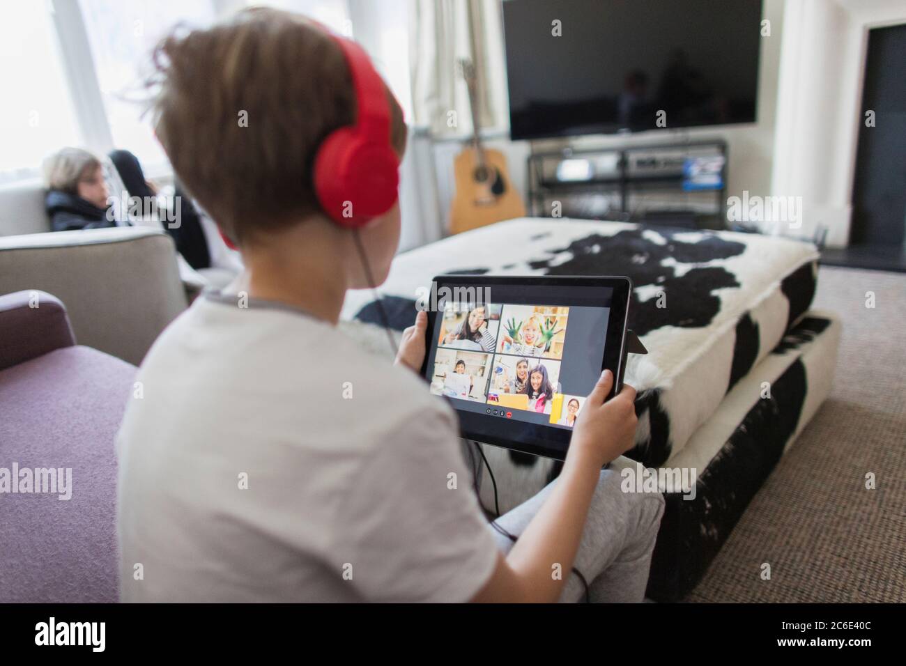 Boy with headphones and digital tablet homeschooling Stock Photo