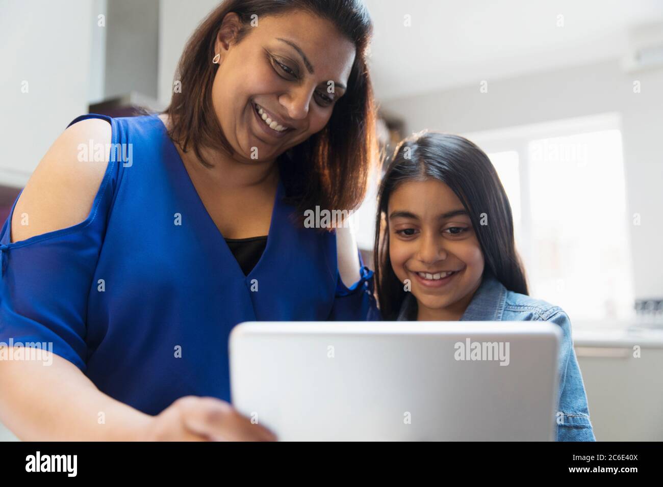 Happy mother and daughter using digital tablet Stock Photo