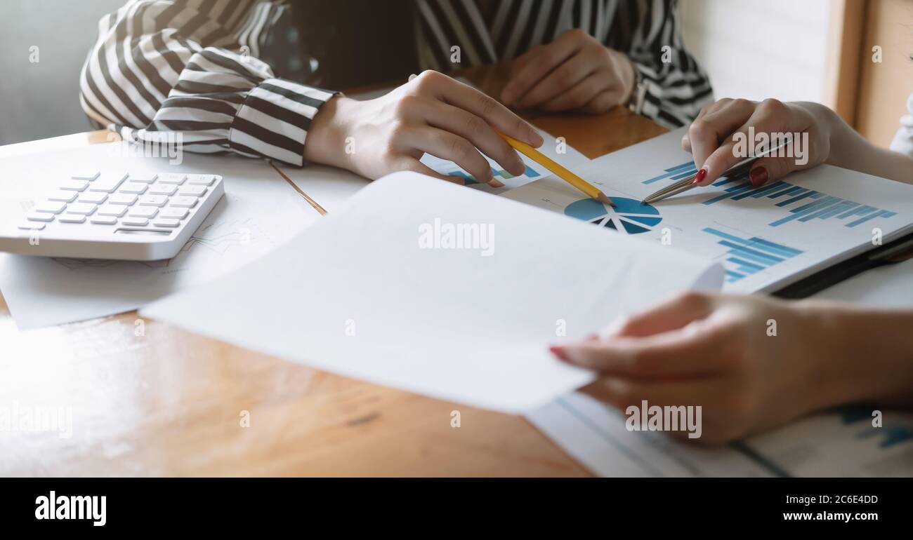 Closeup Group of Business analyzing investment graph from financial report and meeting brainstorming discussing plan Stock Photo