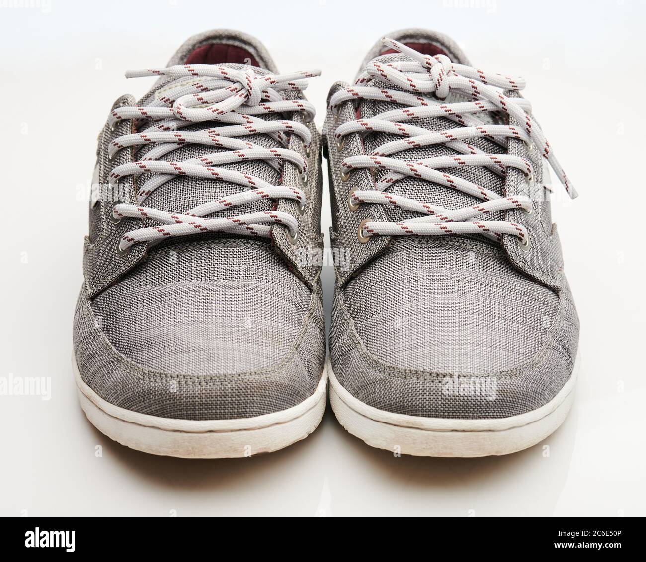 Cloth gray sneakers shoes front view isolated on white background Stock Photo